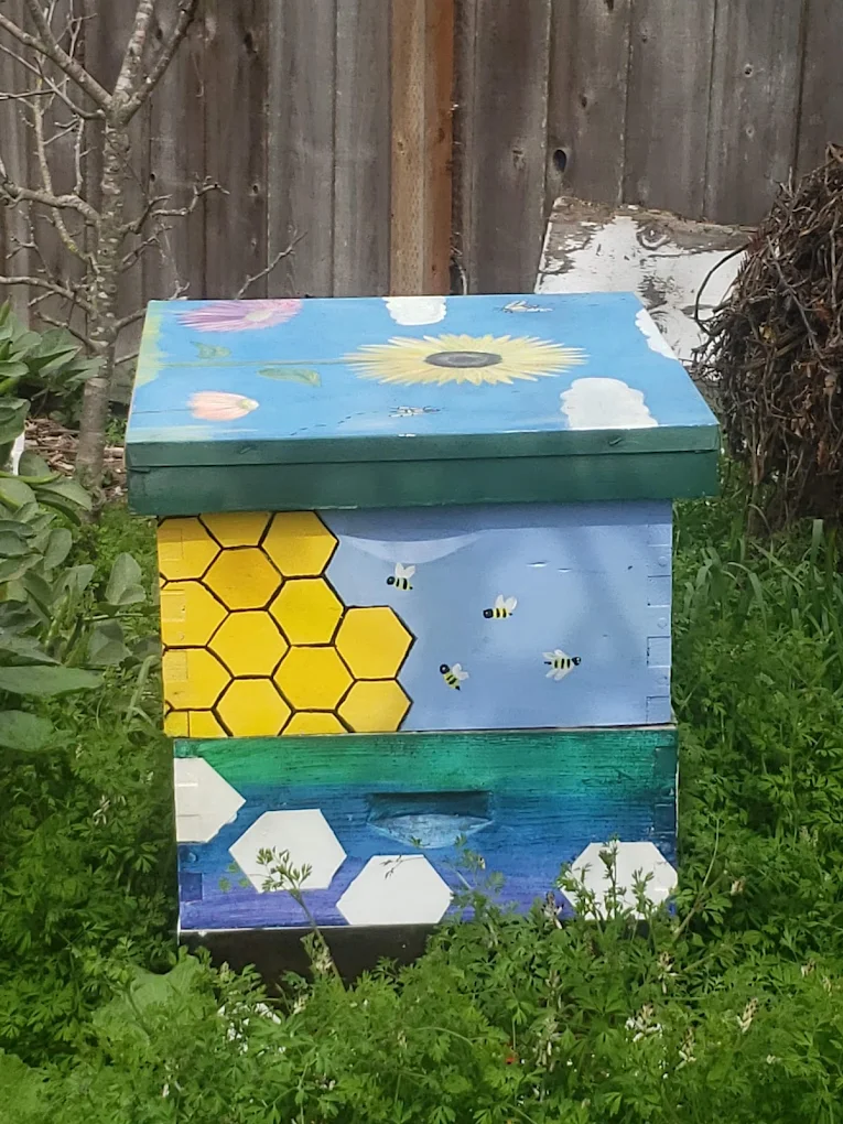 Colorfully painted beehive box in the garden